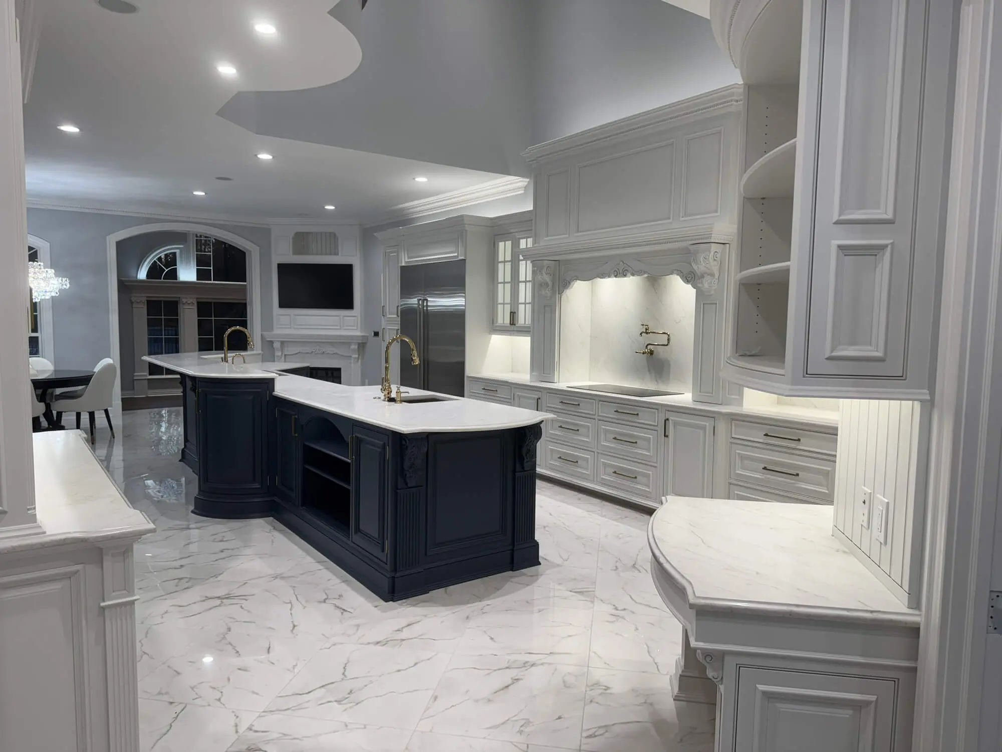 Luxury white kitchen cabinetry with navy island professionally finished by Painters-in-Lititz-PA at Martzall’s Custom Surfaces serving Lititz, PA and surrounding communities