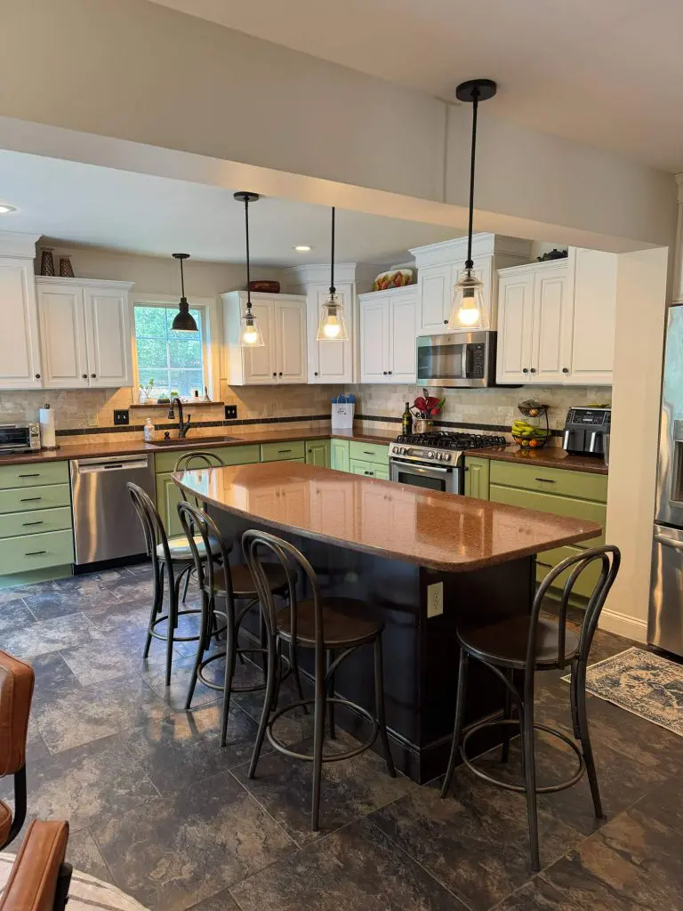 Trust a professional painting company in Lancaster County, PA, to deliver a stunning two-toned kitchen transformation featuring a deep navy blue island and elegant white cabinetry.