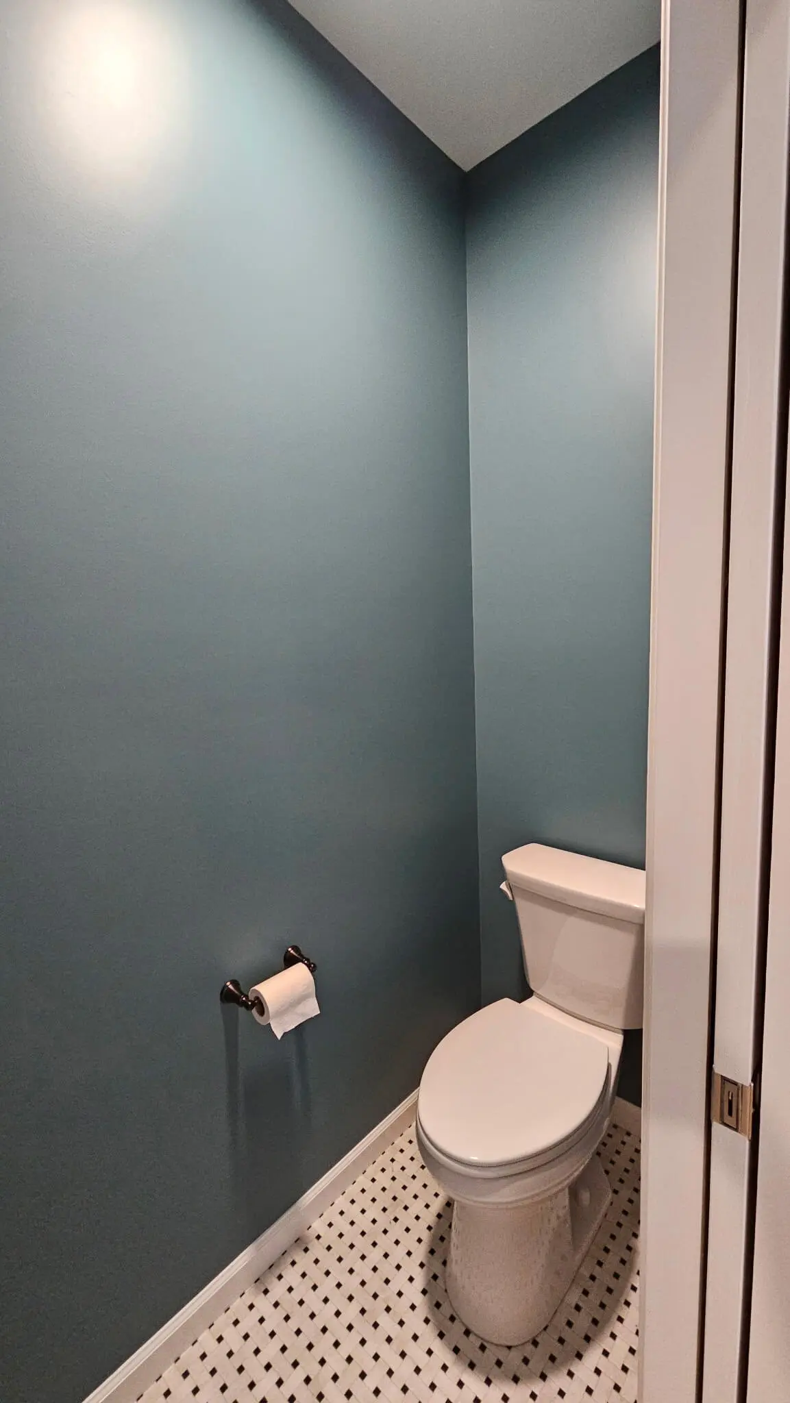 Deep-cleaned teal powder room featuring white mosaic tile flooring sanitised by martzalls custom surface.