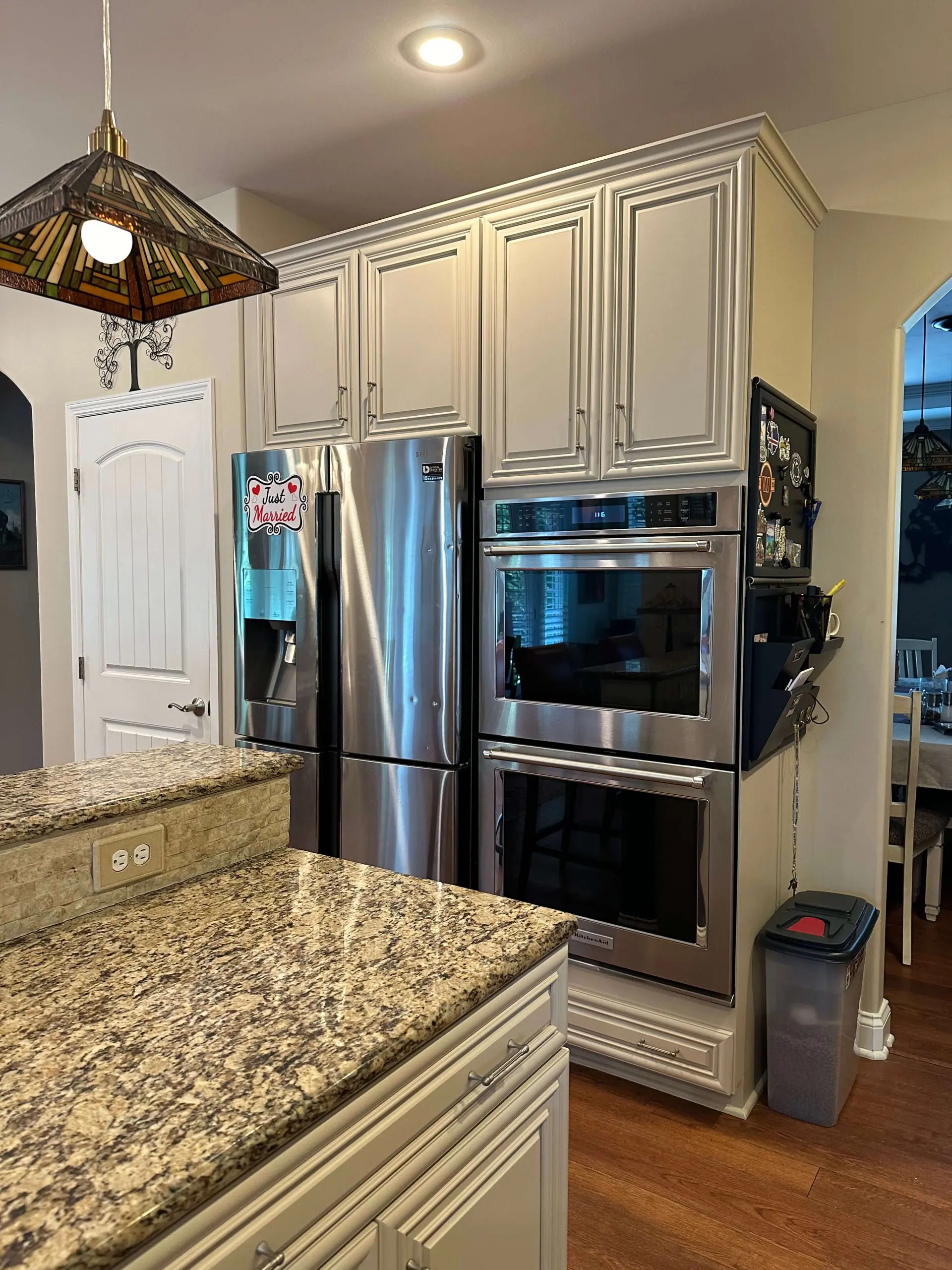 Martzall's Custom Surfaces granite kitchen island countertop featuring elegant tiered edges and neutral cabinetry.