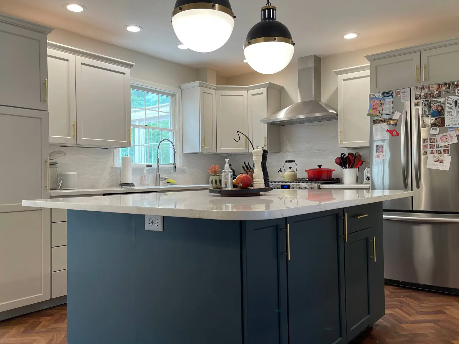 Modern white kitchen with painted cabinets and deep navy blue island in Wyomissing PA