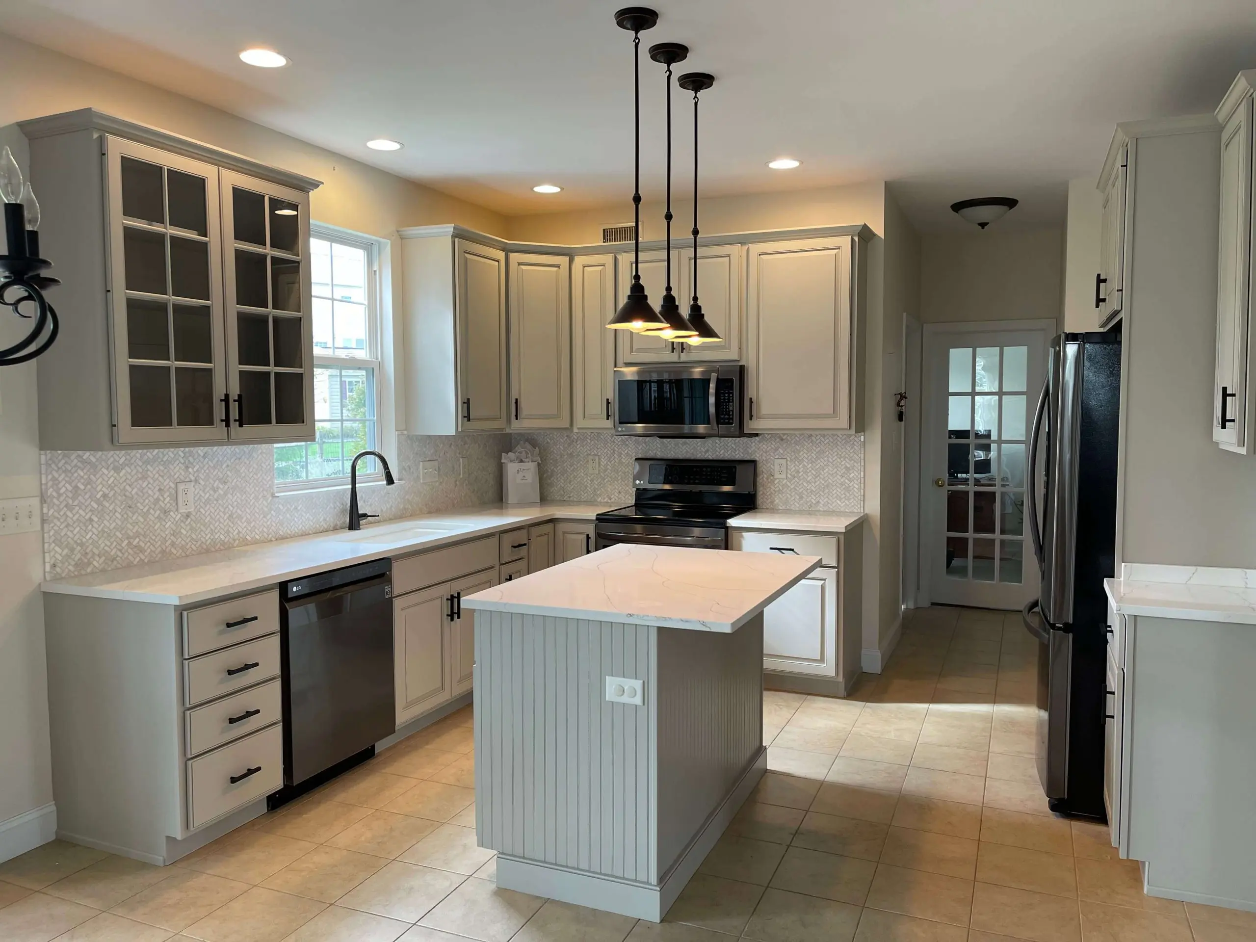 Modern kitchen with off-white painted cabinets and warm recessed lighting creating a clean and refreshed space