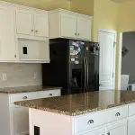 Golden oak kitchen cabinets before the professional cabinet painting process begins