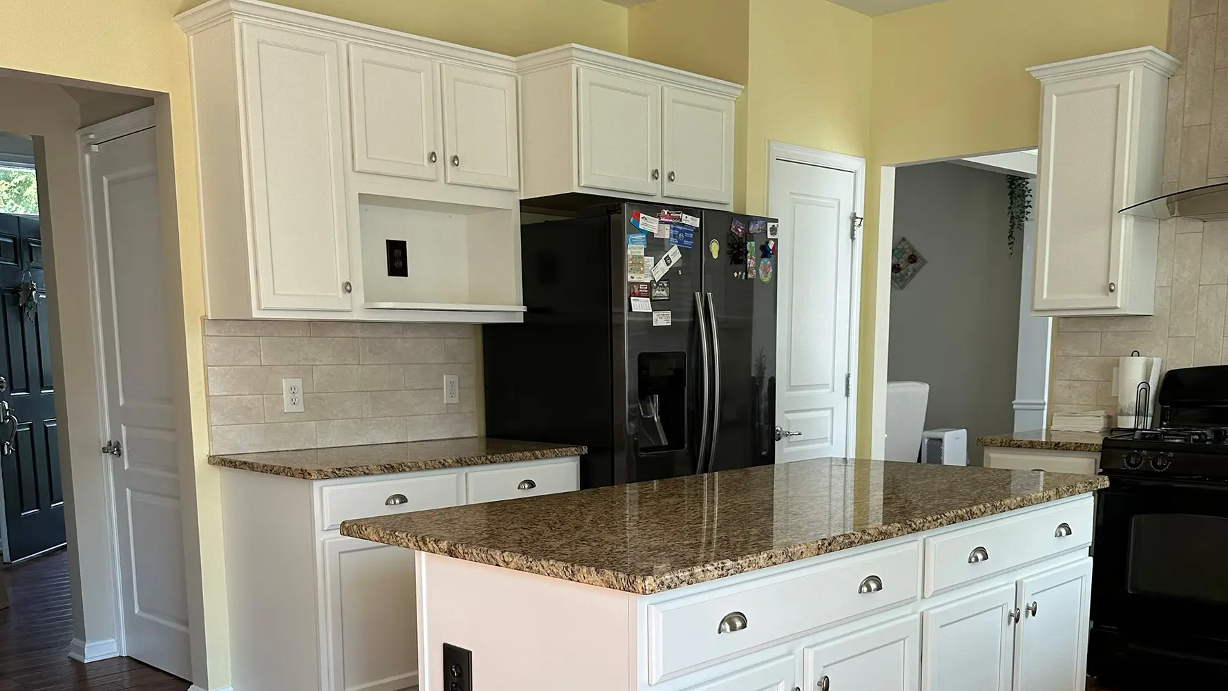 Golden oak kitchen cabinets before the professional cabinet painting process begins