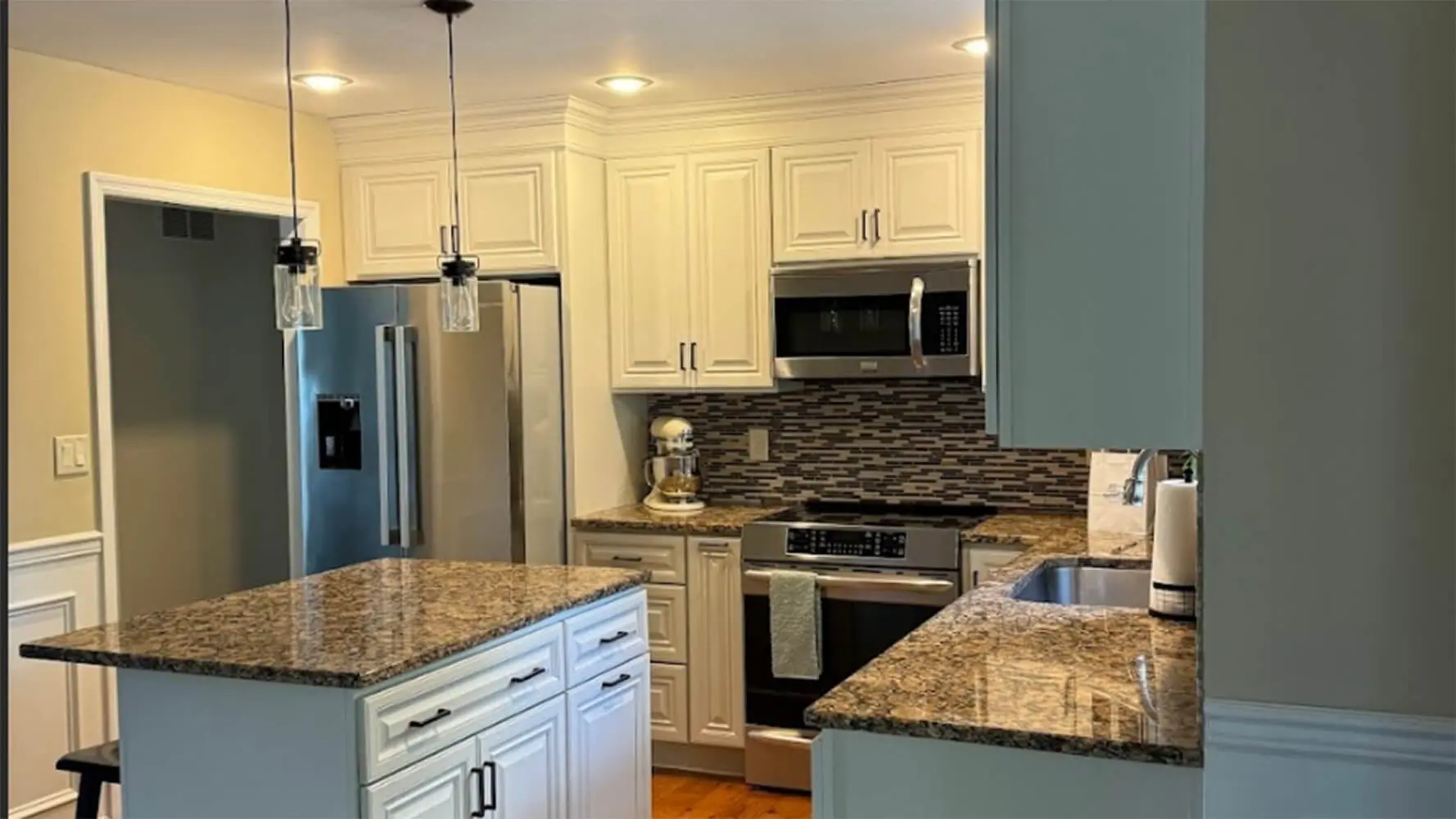 Professionally painted white kitchen cabinets after a cabinet painting project in Lancaster County