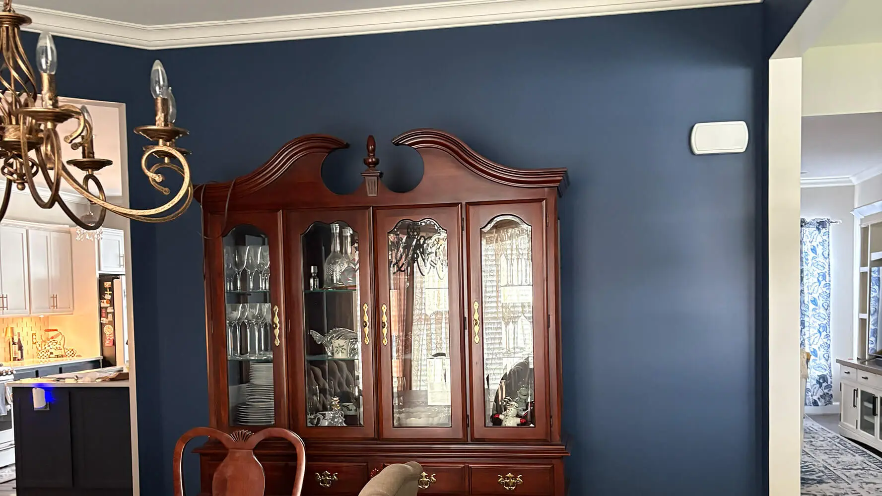 Navy dining room walls and white crown molding completed after a professional interior painting consultation