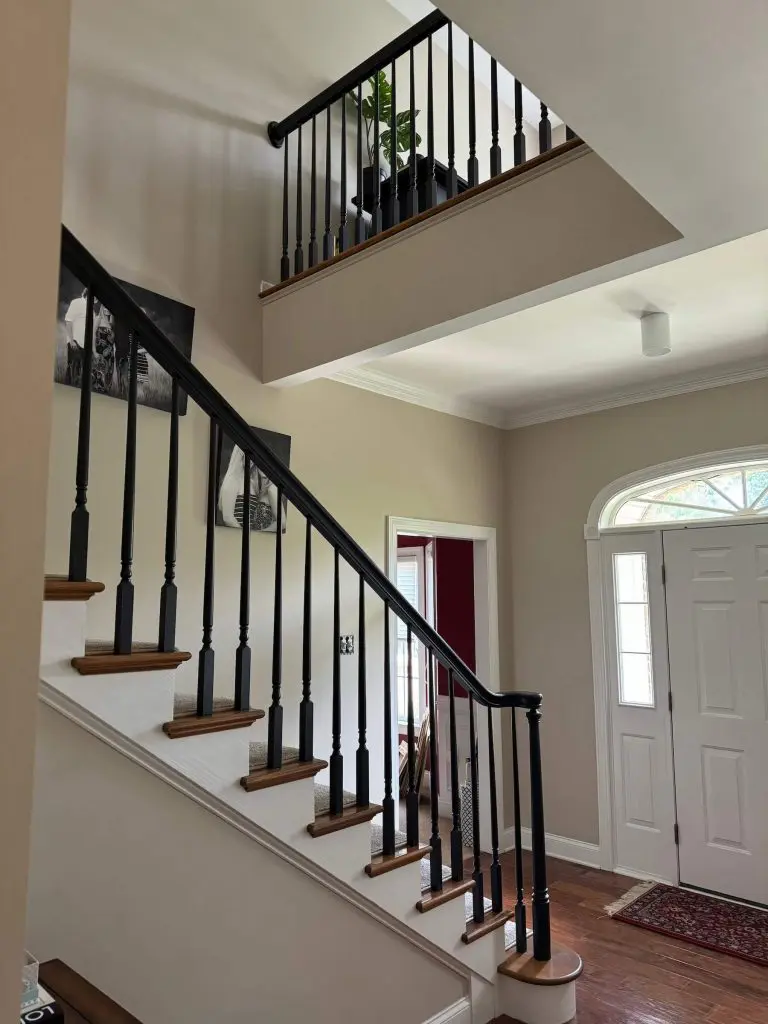 Two-story foyer and staircase landing featuring freshly painted neutral walls and white trim in a Lancaster County, PA home