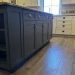Two-tone kitchen with navy blue island and white perimeter cabinets professionally painted by Martzall's Custom Surfaces in Lititz, PA