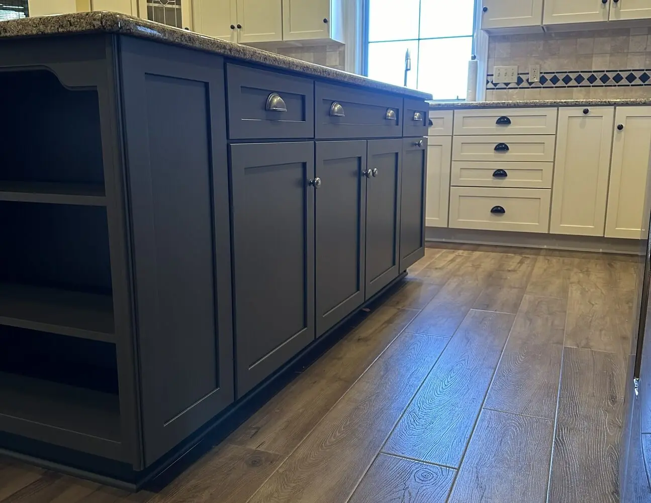 Two-tone kitchen with navy blue island and white perimeter cabinets professionally painted by Martzall's Custom Surfaces in Lititz, PA