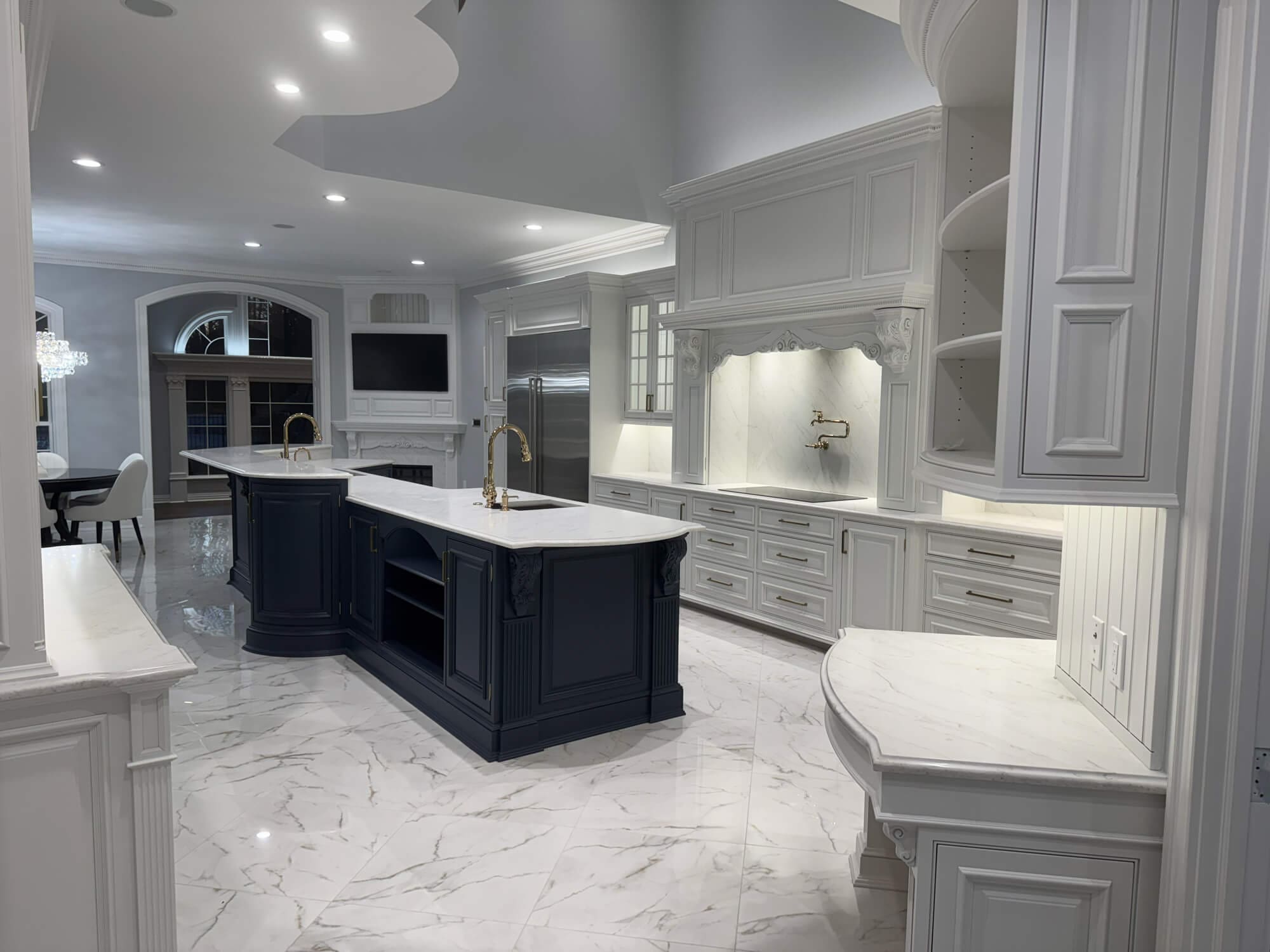 Luxury white kitchen cabinetry with navy island professionally finished by Painters-in-Lititz-PA at Martzall’s Custom Surfaces serving Lititz, PA and surrounding communities