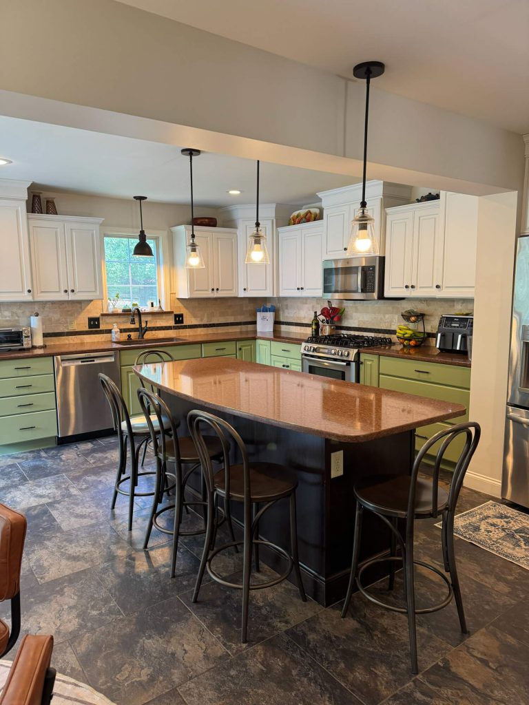 Trust a professional painting company in Lancaster County, PA, to deliver a stunning two-toned kitchen transformation featuring a deep navy blue island and elegant white cabinetry.