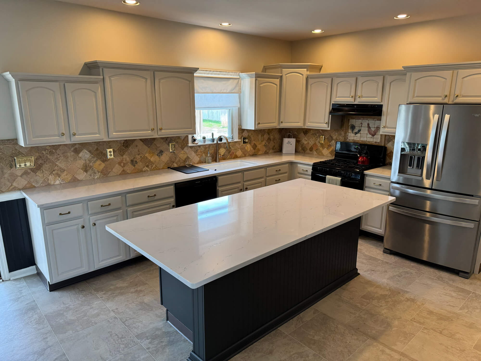 White kitchen cabinets with contrasting dark island professionally painted by Martzall’s Custom Surfaces serving Lititz, PA and surrounding Lancaster County communities