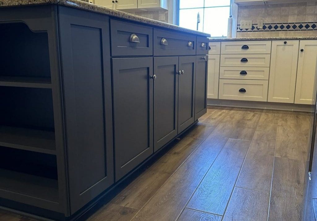 Two-tone kitchen with navy blue island and white perimeter cabinets professionally painted by Martzall's Custom Surfaces in Lititz, PA