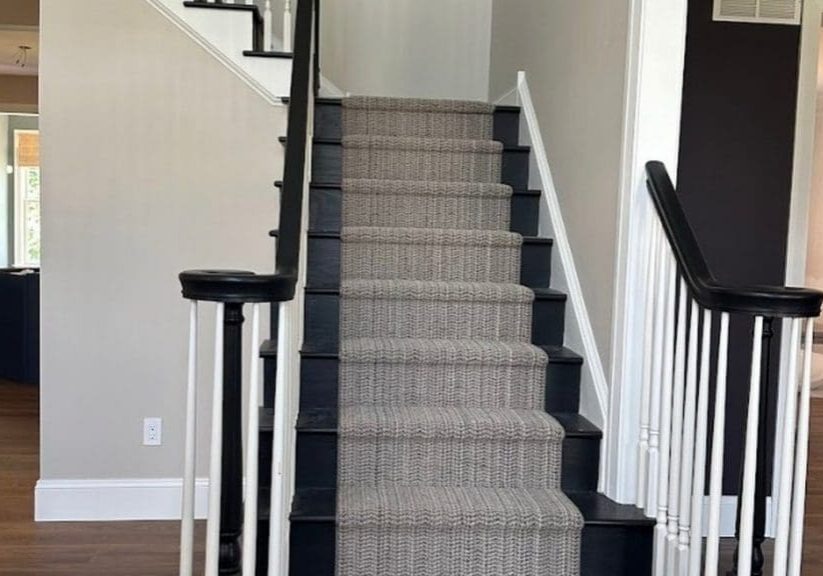 Professionally painted staircase and hallway with taupe walls, white trim, and black railings by Martzall's Custom Surfaces in Lancaster County, PA