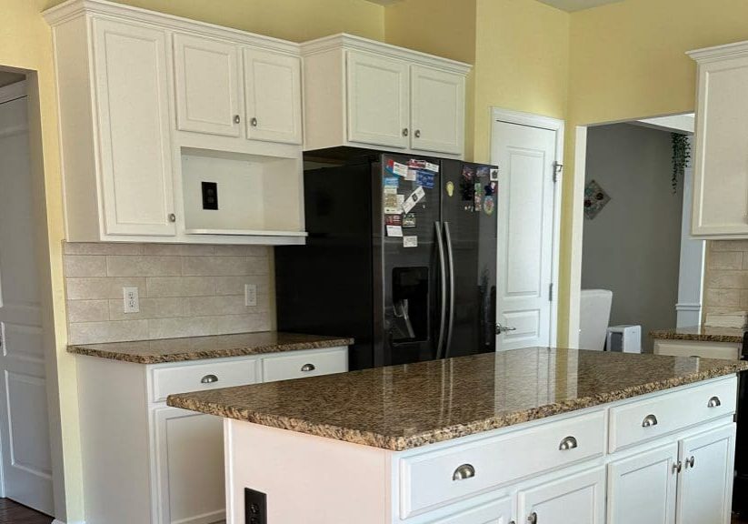Golden oak kitchen cabinets before the professional cabinet painting process begins
